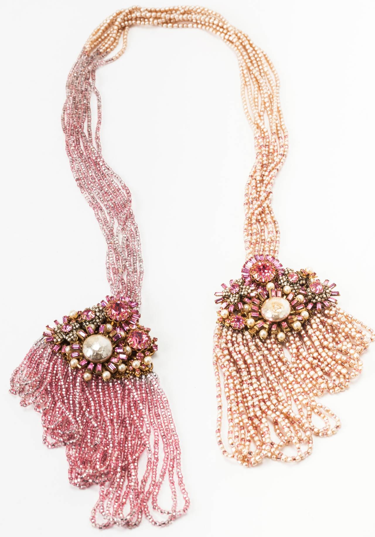 Extraordinary Miriam Haskell Draped Lariat Suite. Unique show piece made of signature Haskell faux pearls, silver lined pink seed beads and Swarovski crystals, all hand sewn onto Russian gilt filgrees. 
There are 2 large stations at the ends of the