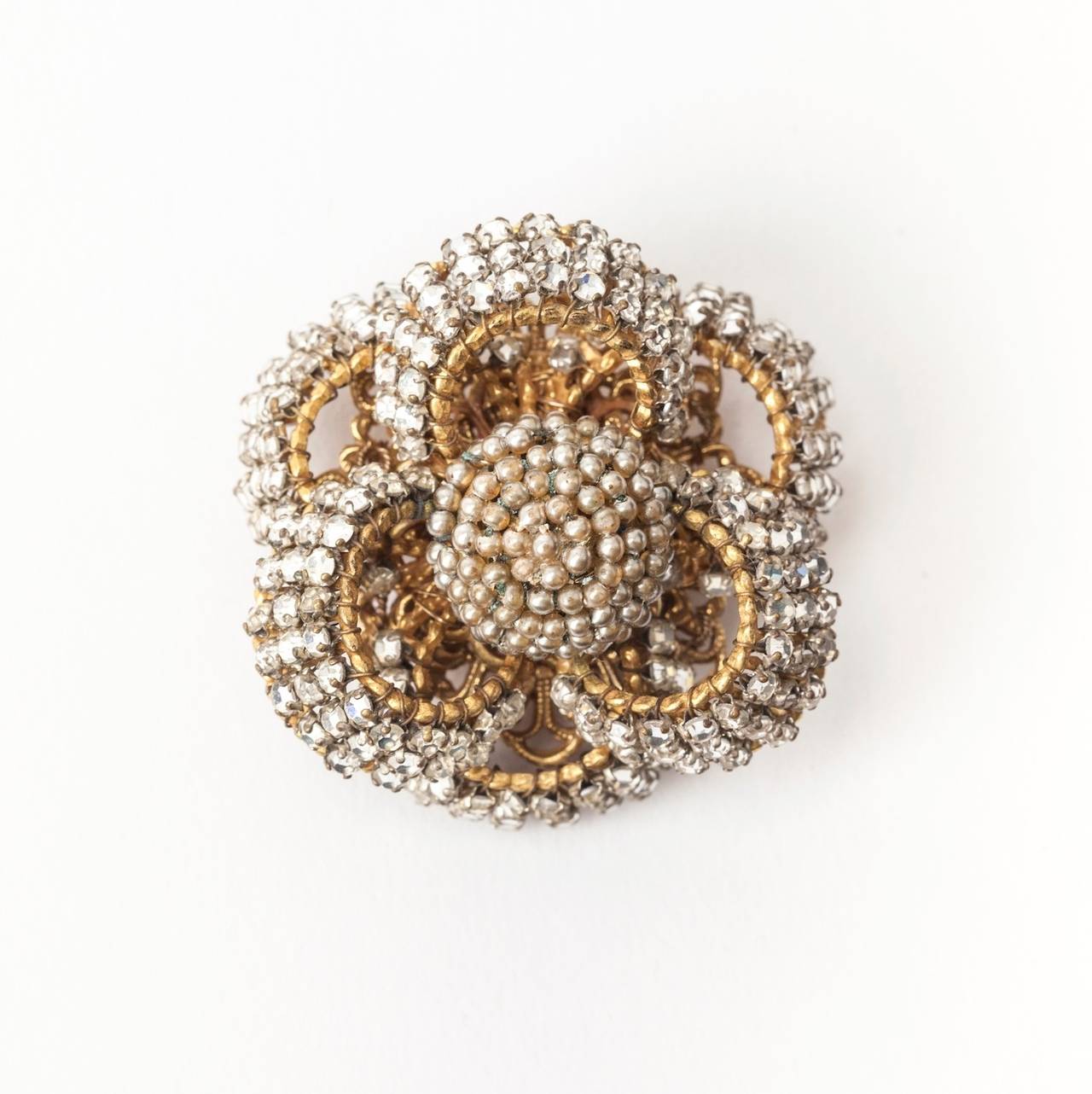 Miriam Haskell's looping   bow circle brooch of signature Russian gilt and hand sewn crystal rose montes and seed pearls. 1940's USA. 
Excellent condition.
L1.75