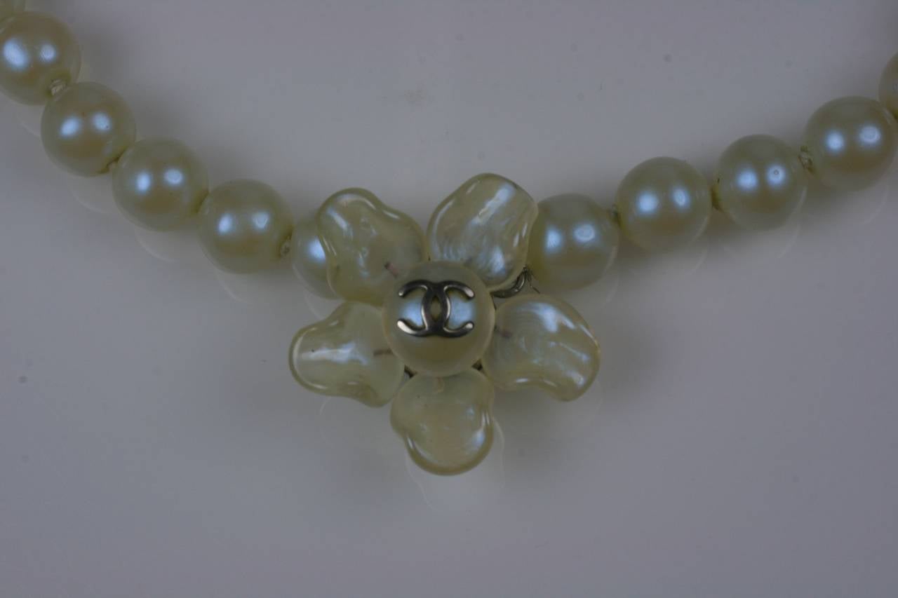 Chanel Iridescent Celadon Pearls by Maison Gripoix. Handmade faux glass pearls are dipped in celadon iridescent finish with a floral center piece with logo.
1990's France. 10mm pearls , 18-20