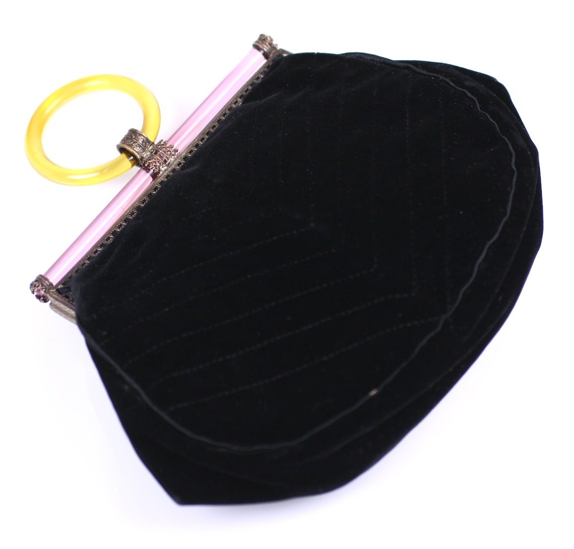 French Art Deco Crystal and Perspex Finger Clutch in quilted black silk velvet from the 1920's. A amber perspex finger ring allows wearer to dangle purse. 
A rosey pink glass rod frames the top edge along with a crystal rod purse pull.
Extremely