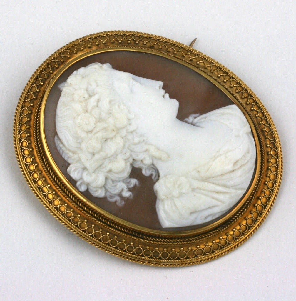 Massive Etruscan Framed Victorian Shell Cameo from the mid 19th Century. Beautifully carved cameo of young maiden with ornate Etruscan work border in heavy gauge 14k gold. Exquisite quality period cameo. 
2.75