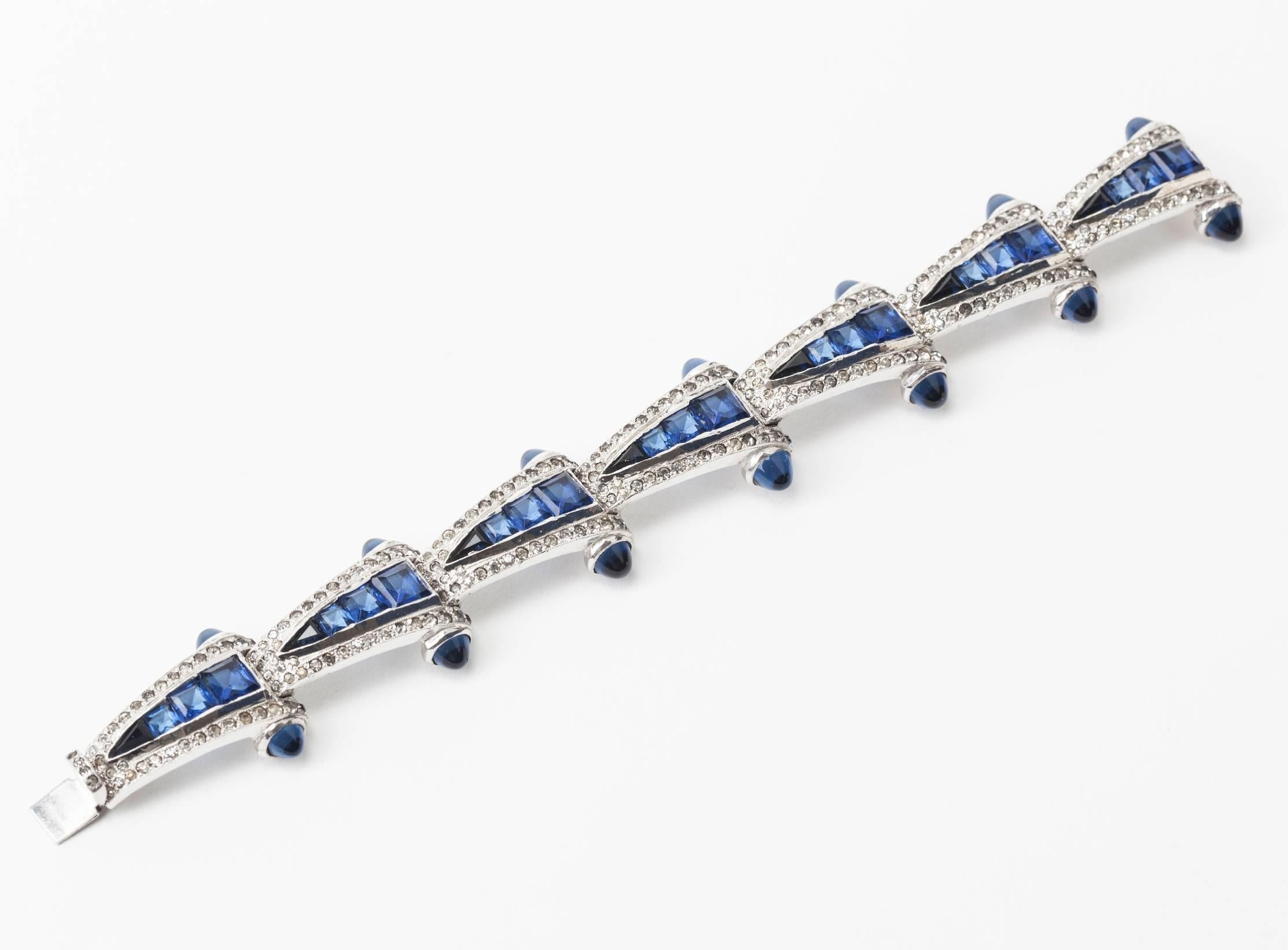Wonderful Art Deco Bracelet with Calibre Set Faux Sapphires. Links are triangular in form with unusually cut faux sapphires edged in crystal pastes. 
High quality rhodium finish. Very possibly made by Ralph DeRosa in the Art Deco period. 7
