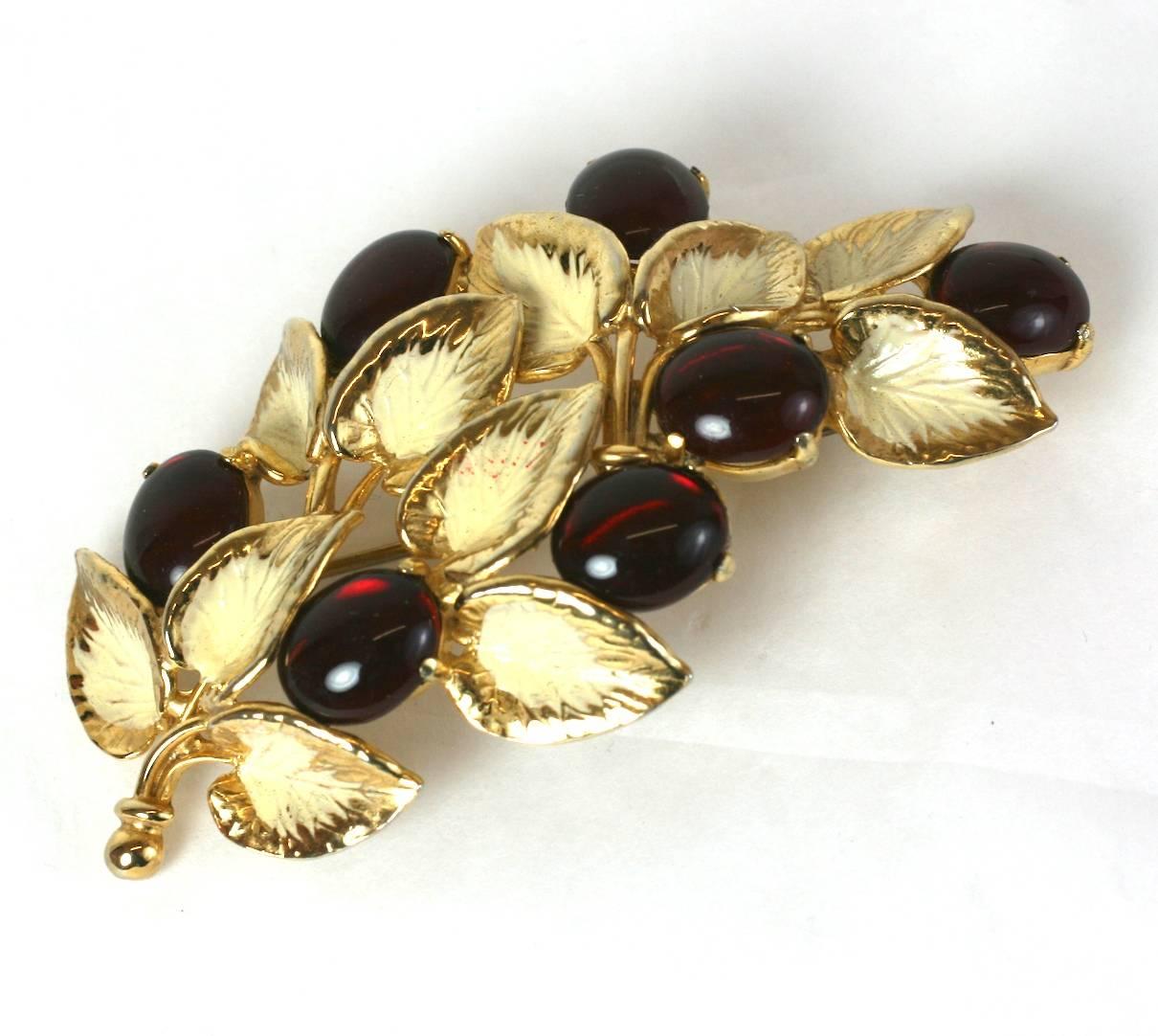 Schiaparelli's lovely garnet pate de verre cabocheon naturalistic berry branch brooch. Of gilt metal and ivory colored cold enamel.
Excellent Condition, Length 3.50