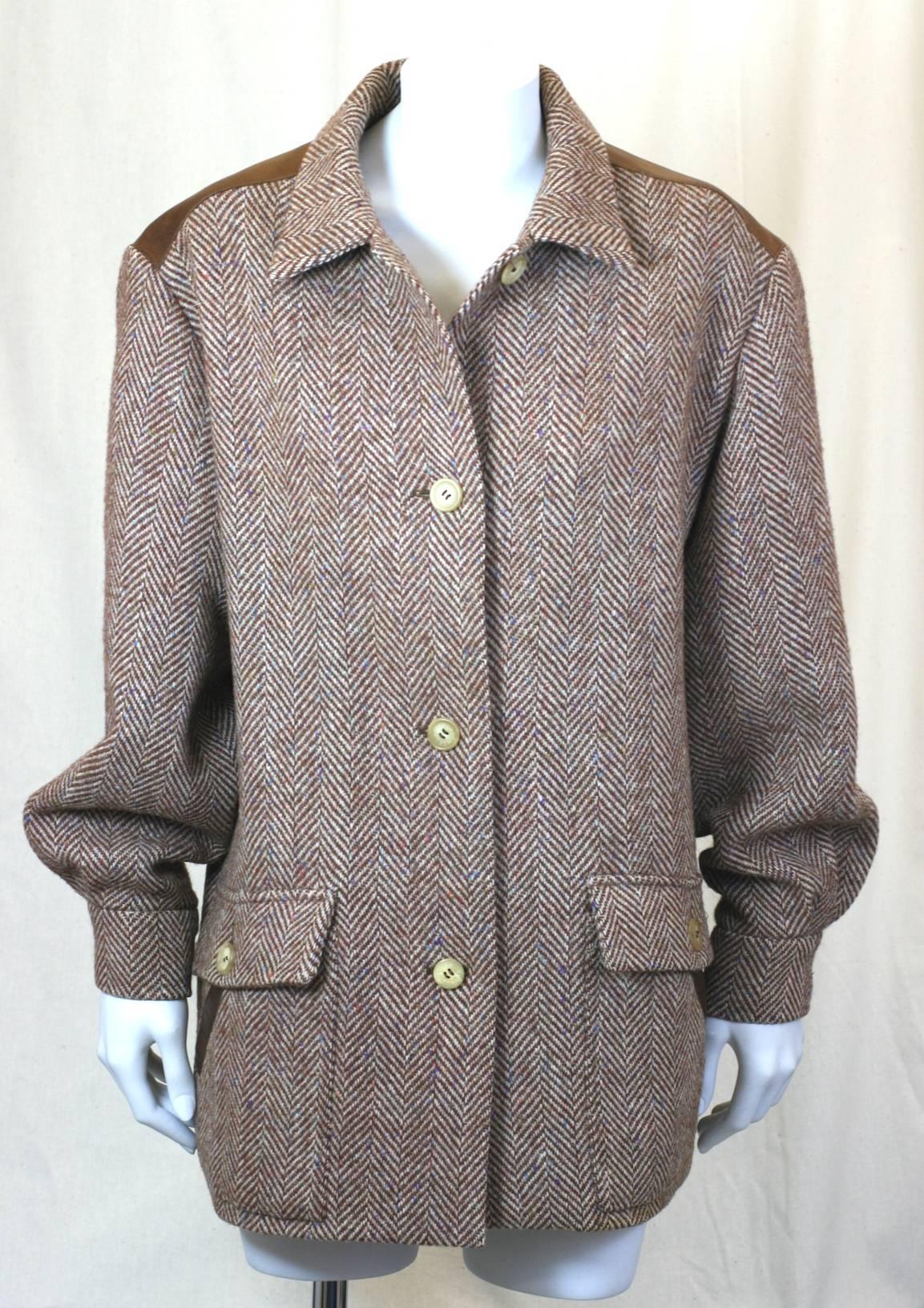 Hermes Tweed and Leather Trimmed Jacket. Brown wool herringbone Harris tweed with amazing muliti colored flecks. Hermes logo horn buttons with wide self tweed belt. Leather yoke and slash pocket trim. Excellent condition. Size 42 Eu. 