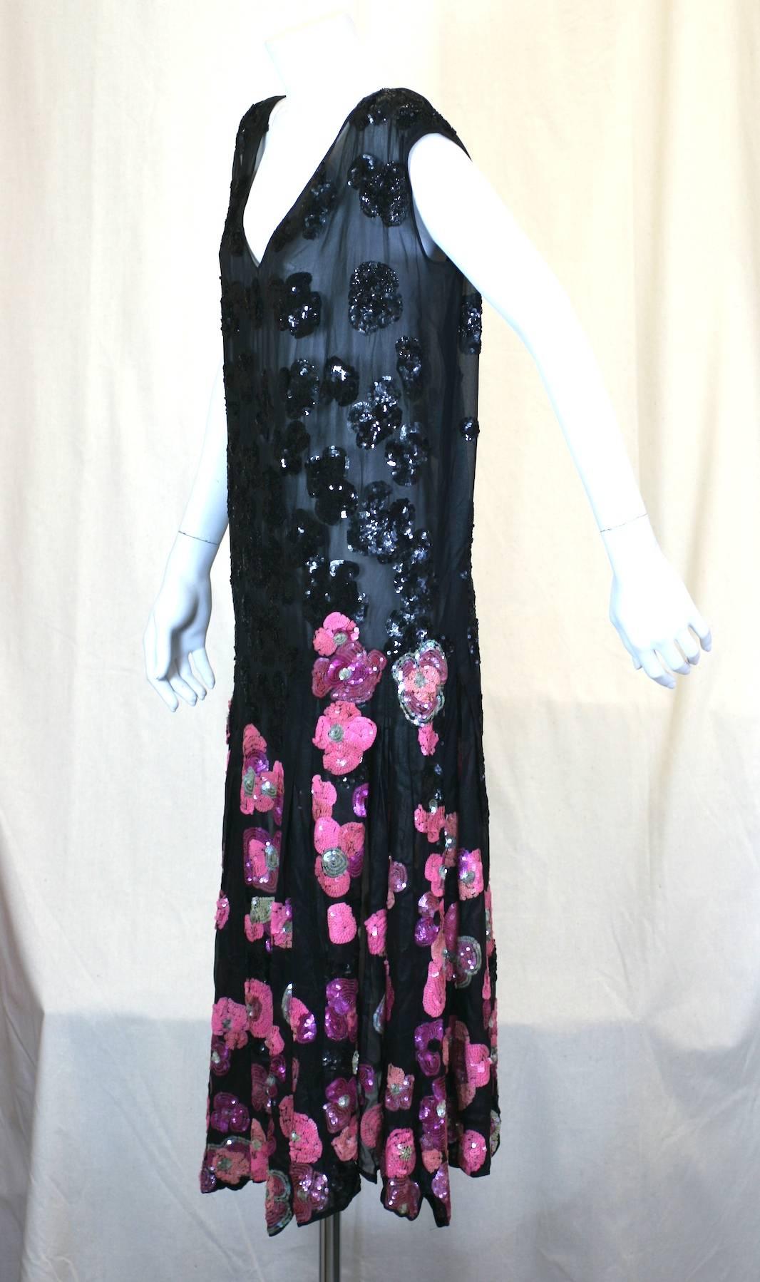 Unusual 1920s French Art Deco flapper evening dress of Couture Quality. Luminiscent black laquered silk organza-chiffon, hand applied with paillette  embroidery of abstract poppy flower heads in black, pink, purples, accented with silver seafoam