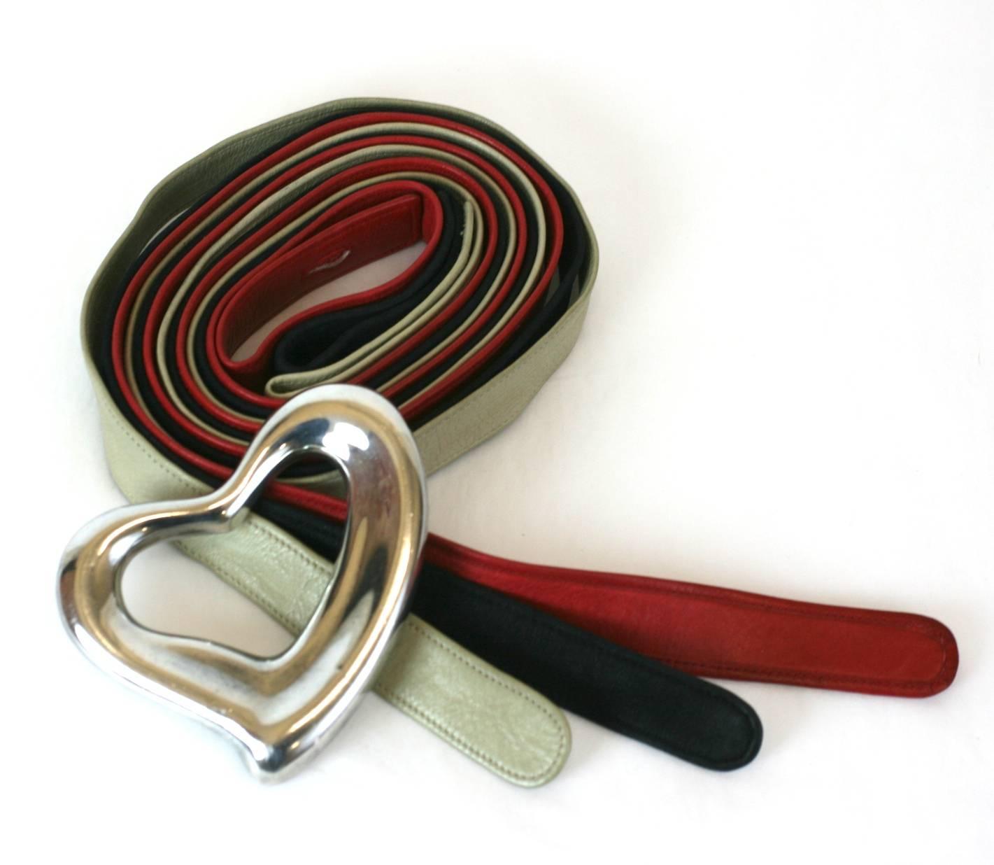 Elsa Peretti's iconic Heart Belt suite for Tiffany and Co. with an assortment of rare interchangeable leather belts in Halston's favorite ivory, black and red tones. Large scale sterling heart buckle made in Spain for Tiffany in 1975. 
In the