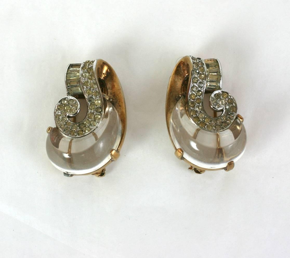 Pair of Trifari Retro molded lucite Jelly Belly clip brooches of rose gold plated metal with crystal pave. High style clip brooches meant to be scattered along necklines or lapels.
Marked: Trifari with Crown, lucite made to replicate carved rock