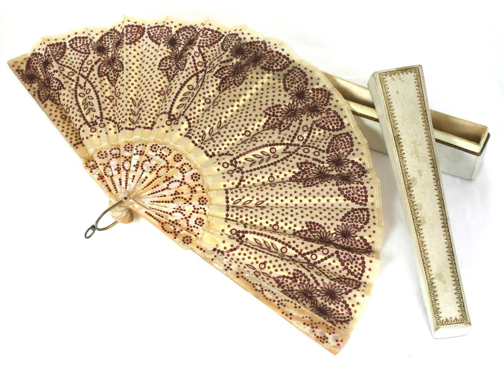 Charming Victorian Sequined fan with beautifully colored rasberry gelatin sequins. Incredibly ornate flower and leaf pattern on a sequin dot base, completely hand embroidered. Inlaid and dyed dots inserted on mother of pearl with bone stays. French