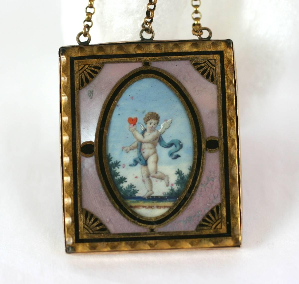 Charming and rare 18th Century Love Token Pendant,  hand painted watercolor of angel carrying a red heart, set under glass in a verre eglomise frame. The beautifully detailed miniature is set into iridescent mother of pearl and has a silk fabric