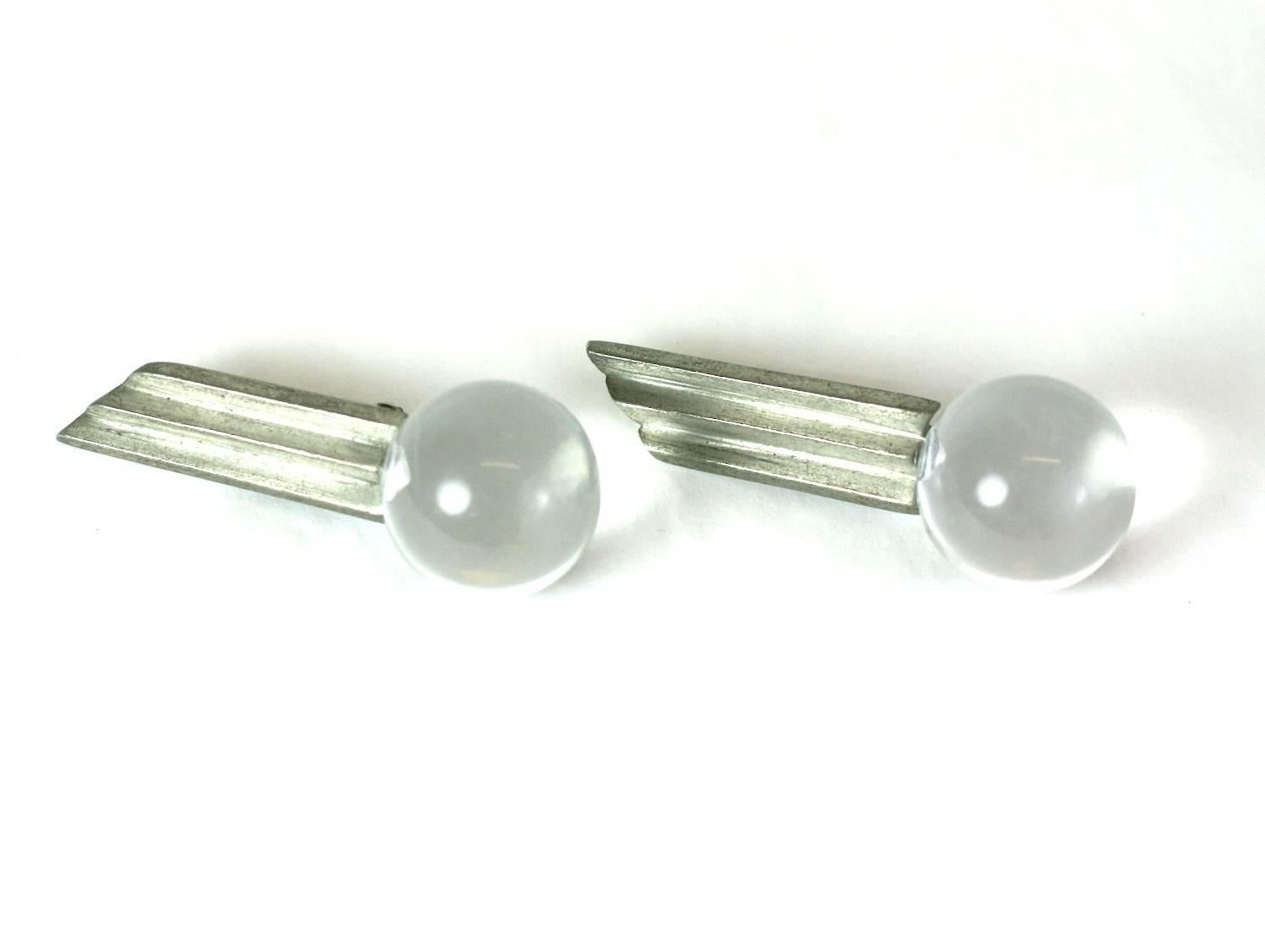 Unusual Deco Style Lucite ball ear clips from the 1980's designed to be worn at an angle up the ear. Pewter toned step motif ends in a large lucite ball, with clip back fittings. 1980's USA. 2.25