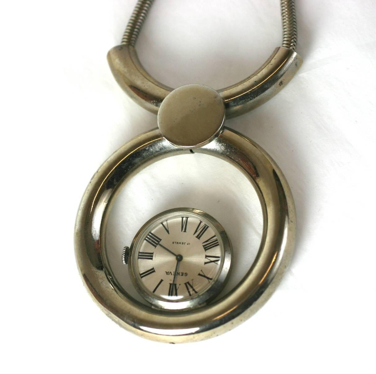 Large Mod Swiss Pendant Watch necklace made circa 1960's, Switzerland. Chrome metal tubing forms pendant with floating watch held by a thick silver snake chain. 1960's Swiss. Excellent condition. 
Chain 24