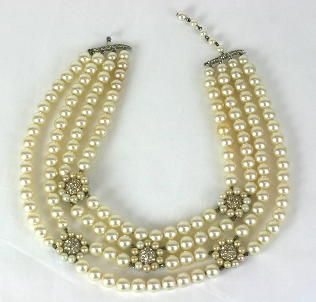 Elegant Trifari multistrand faux pearl and diamonte necklace from the 1960's. Pearls are attached to floral stations with pave centers. Adjustable length. 13