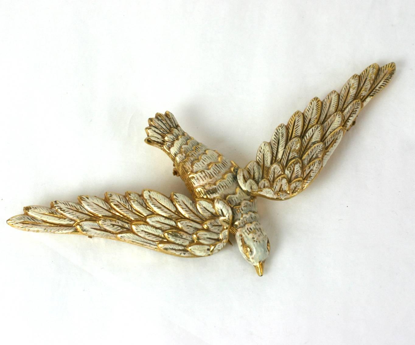 Unusual articulated Art Deco flying dove brooch of gilt metal and off white enamel. Wings can be positioned in different positions by changing placement of clips on garment.  Excellent Condition. 1940's USA.
L 3.75