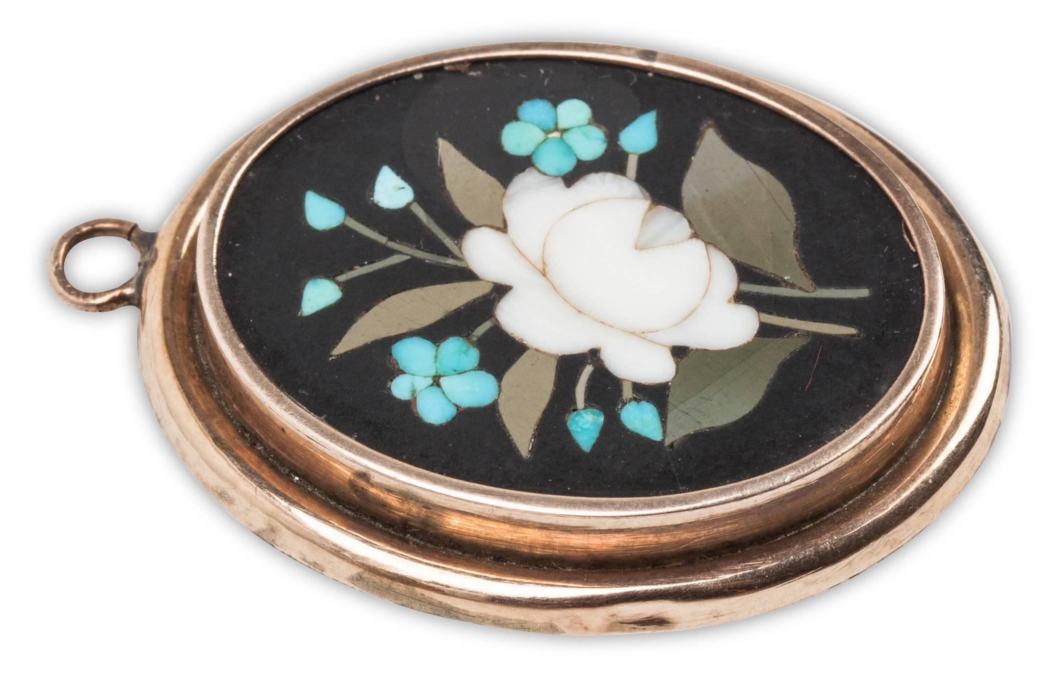 Viktorianische Pietra Dura Medaillon aus dem späten 19. Jahrhundert in 9K Gold gesetzt. Eingelegte Hartsteine formen ein florales Muster aus Türkis, Alabaster und Achat auf einem Onyxsockel. Glasmedaillon auf der Rückseite. Italienische Pietra dura,