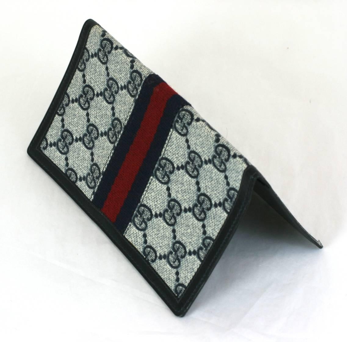 Gucci Logo Billfold from Italy. Signature GG print textile with navy and red racing stripe twill ribbon. Lined in black calf leather. Italy 1970's. 6.25