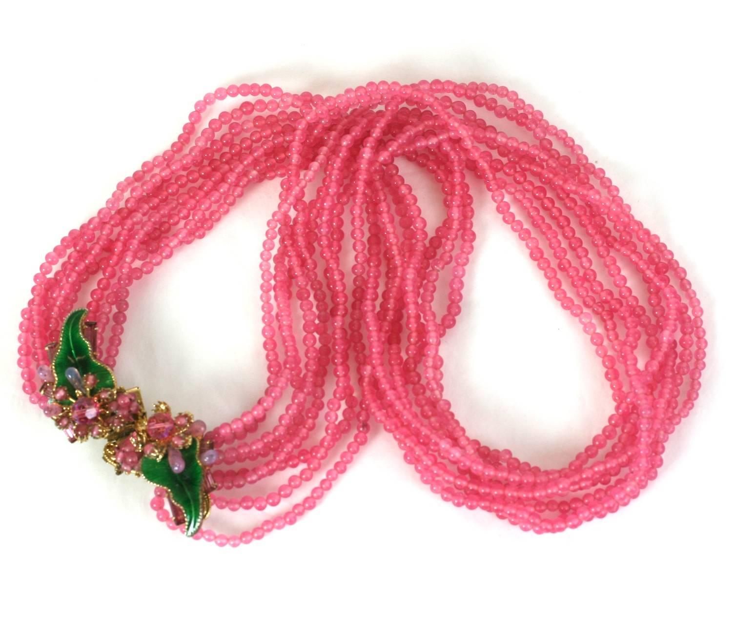 Eugenie graduated multistrand pink pate de verre bead necklace with elaborate woven clasp of enameled leaves, pink crystal baguettes and pink aurora beads. 1950's USA. Excellent condition. 
19