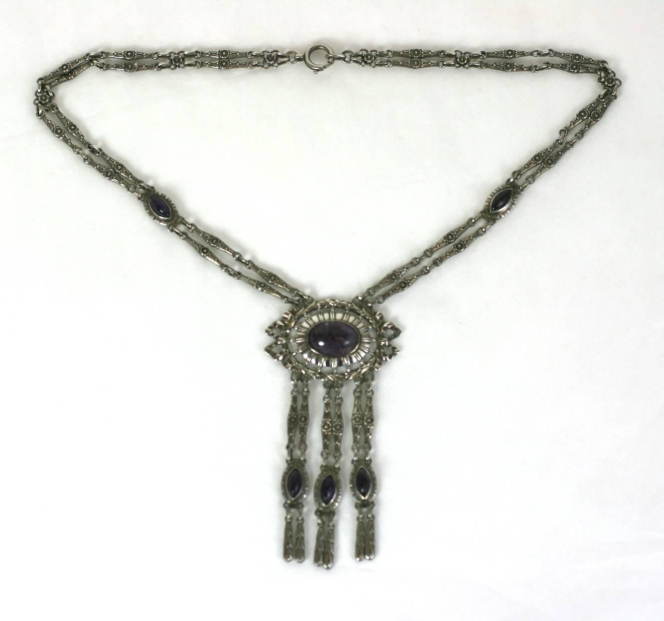 Silver and Amythest Edwardian Necklace of European origin. Lovely Neoclassical motifs are used throughout with navette and oval genuine amythests. Heavy quality construction with lovely swag/ribbon detailing. Germany 1910.
800 grade silver.