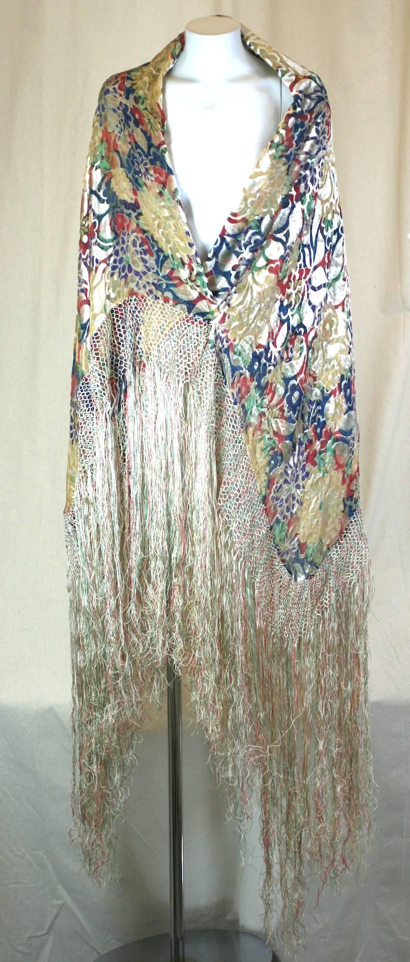 Rare, Art Deco Liberty of London printed silk chiffon souffle and devore cut velvet  shawl from the early 20th century. 
This vari colored muted shawl features Liberty and Co's classic printed chiffon souffle ground, reinterpreted for the Art Deco