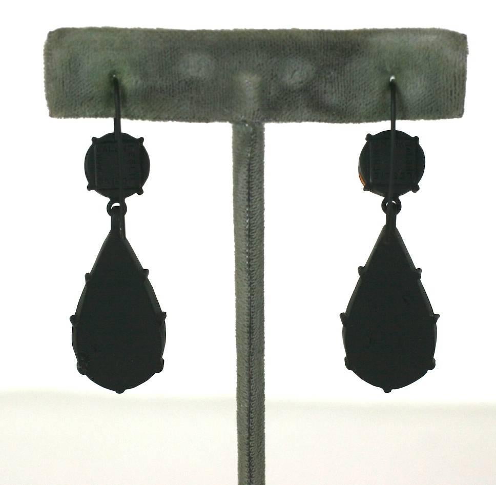 Ruby Foiled Drop Earrings from the Parisian studios of MWLC. Elegant drop earrings in ruby pate de verre with inserted foils made in Georgian style, closed settings.
The color pops against the blackened metal finish and the foils inside provide a