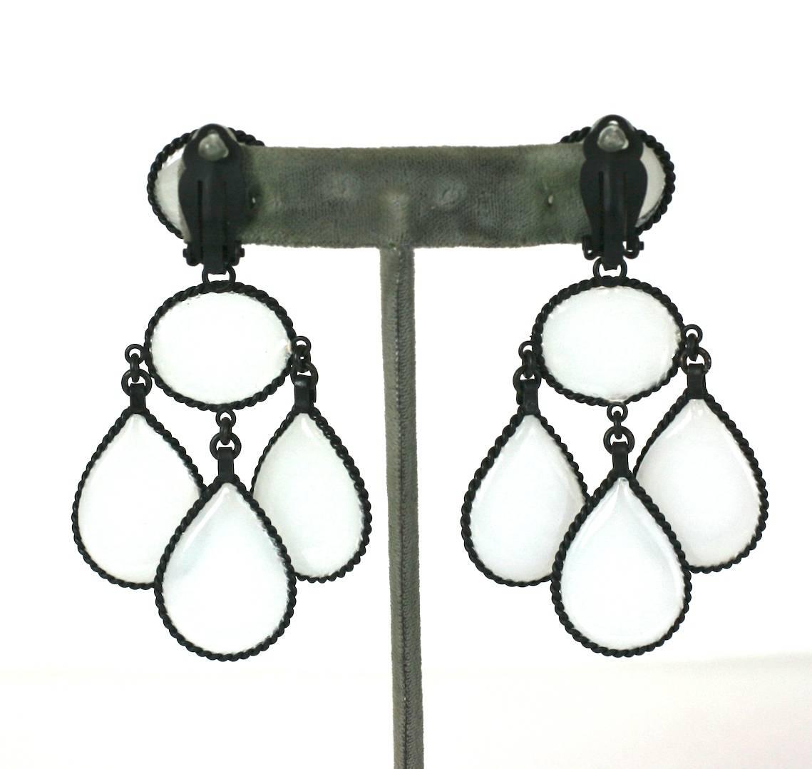 Large Opaline Girandole Earclips, hand made in the Parisian studios of Mark Walsh, Leslie Chin.
A modern twist on an antique configuration. Transluscent opaline poured glass pear form drops set in matte blackened twisted metal settings. Clip back