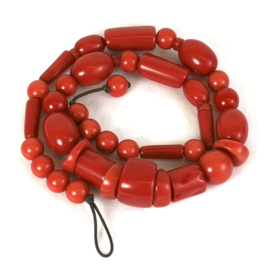 Monies style signature resin barbaric style, faux coral necklace of vari size polished and naturalistic beads  Strung on brown woven cotton cord with bead and self loop closure, 1990's, Unsigned.
Excellent Condition.
L 33.25