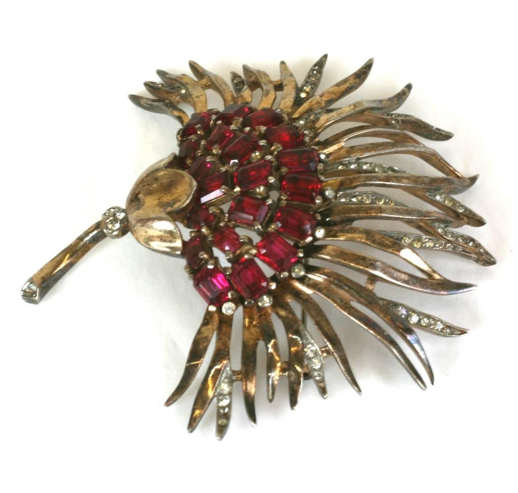 Large, Trifari Retro Sterling Vermeil Chrysanthemum Brooch from the 1940's. Beautiful design with faux square cut rubies forming the center with a gilt and pave petal surround. Excellent Condition. 1940's USA. 
L 3.25