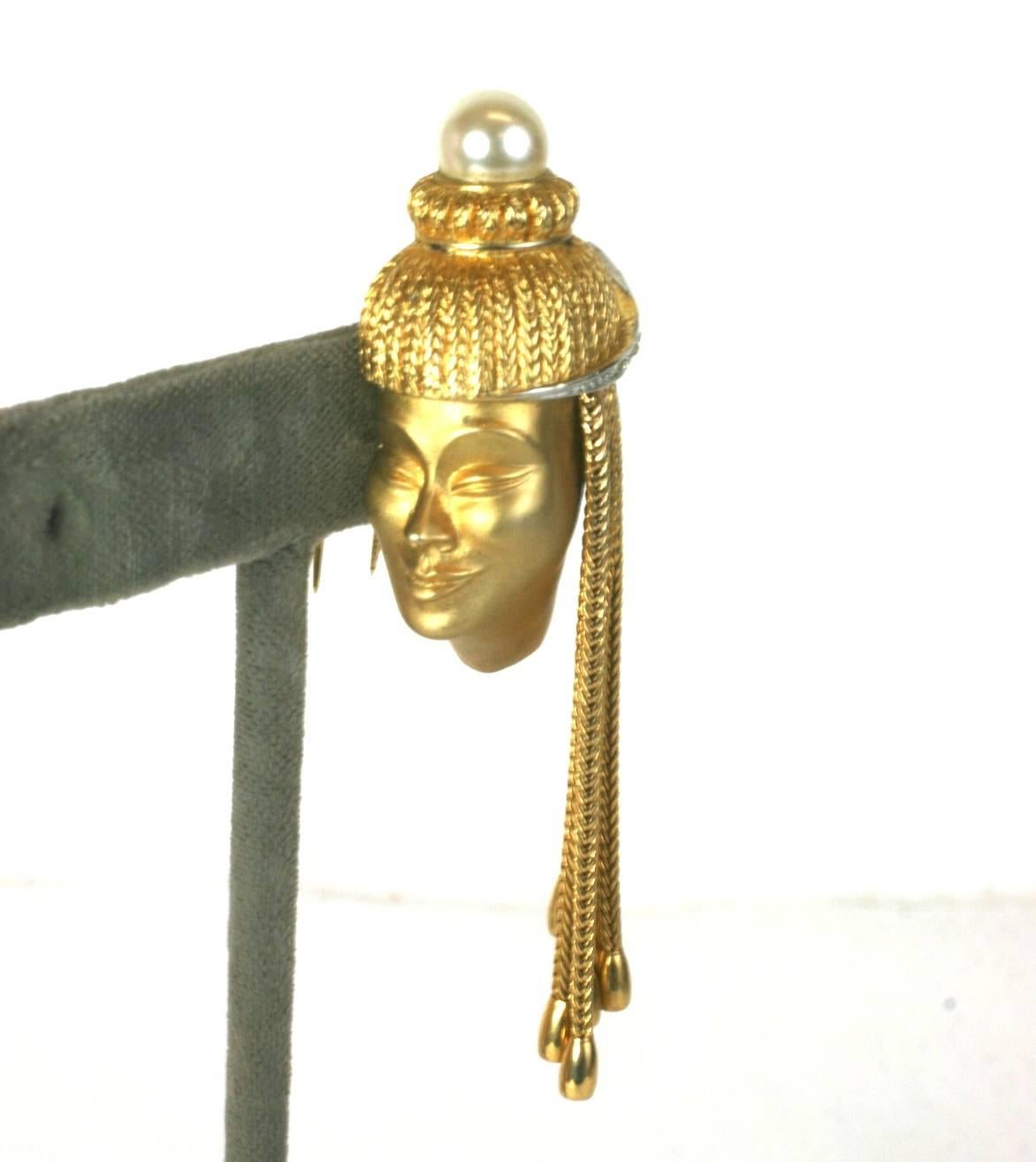 Charming Marcel Boucher Genie Clip. Unusual clip with a smiling genie with hair made from gilt fox chains with pave accents. A faux pearl is the accent at the top of the clip. The face is detailed in a satin finish, contrasting against the high gold