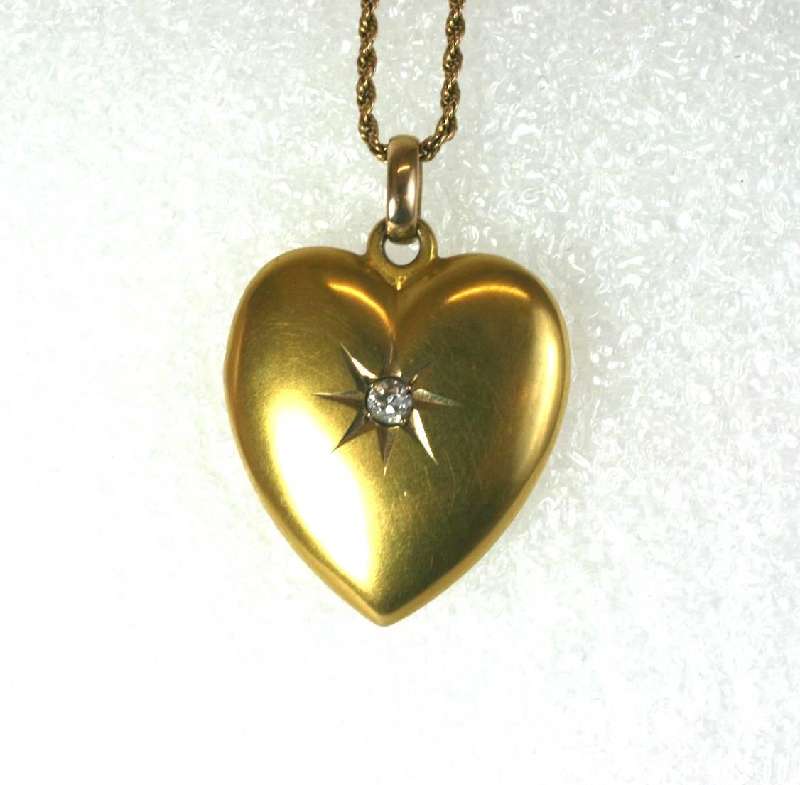 Lovely Antique Victorian Heart Pendant with antique, star set 10 point old cut diamond. Set in 14k gold with a period conjoined monogram on back. This heart pendant does not open.
Twisted antique 16