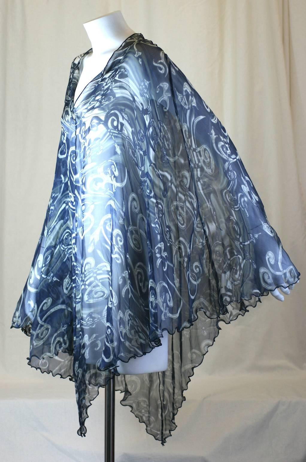 Salvatore  Ferragamo printed silk chiffon poncho. Printed swirling motifs in shades of white and gray on a navy background. Excellent Condition.
Length 36
