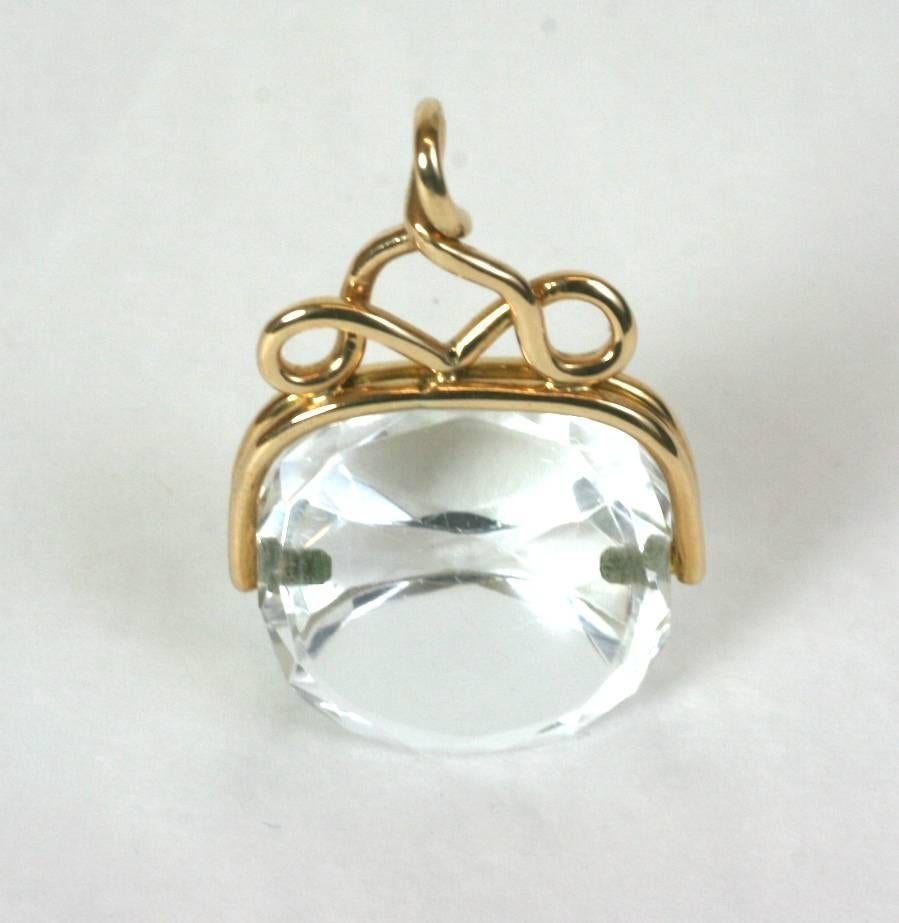 Rock Crystal Victorian swivel fob set in 10K gold. Lovely, simple lines form the wire work surround which holds the 3 sided rock crystal fob, which still remains uncarved. 
A lovely pendant with minimalist lines, over 125 years old. Great on a long