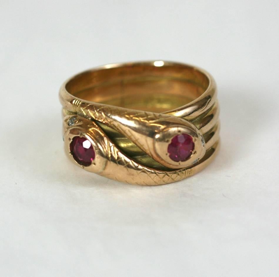 Wonderful Victorian Double Snake Ring set in 15 Carat slightly rose gold with natural rubies set into heads and diamond eyes. Wonderful condition with the 2 entwined snakes representing eternity and love as the one body connects to 2 heads.
Both