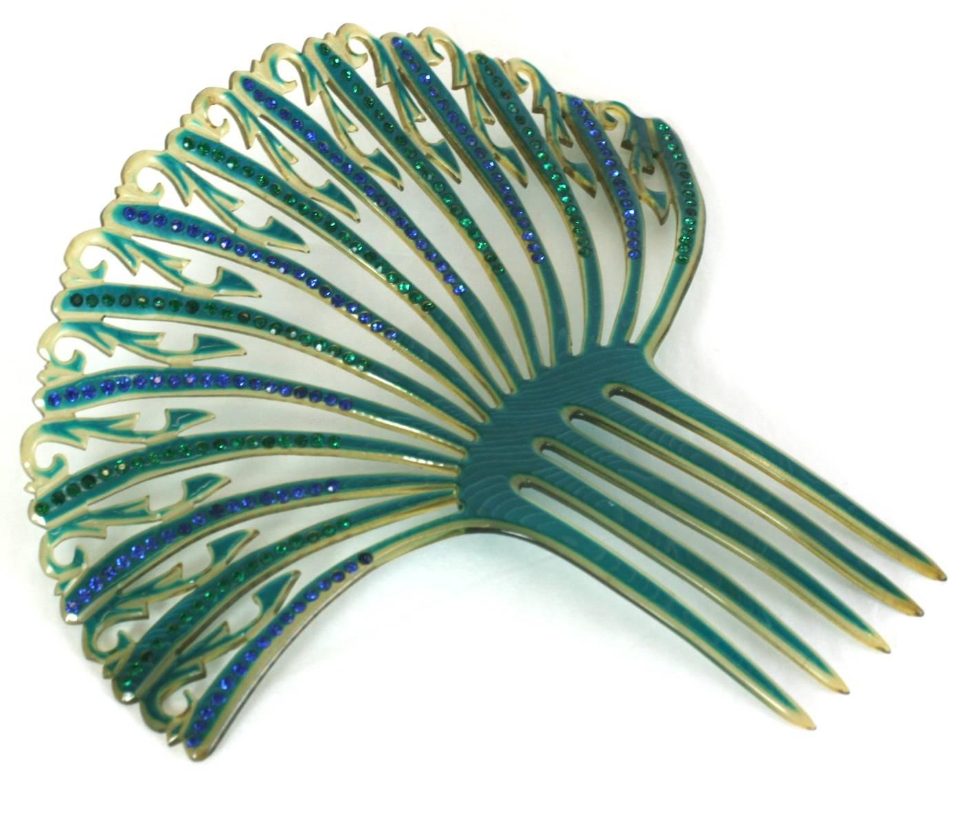 Elaborate Art Deco French openwork celluloid comb with green and blue pastes from the 1930's. Amazing colorations. France 1930's. Excellent condition. 
7.5