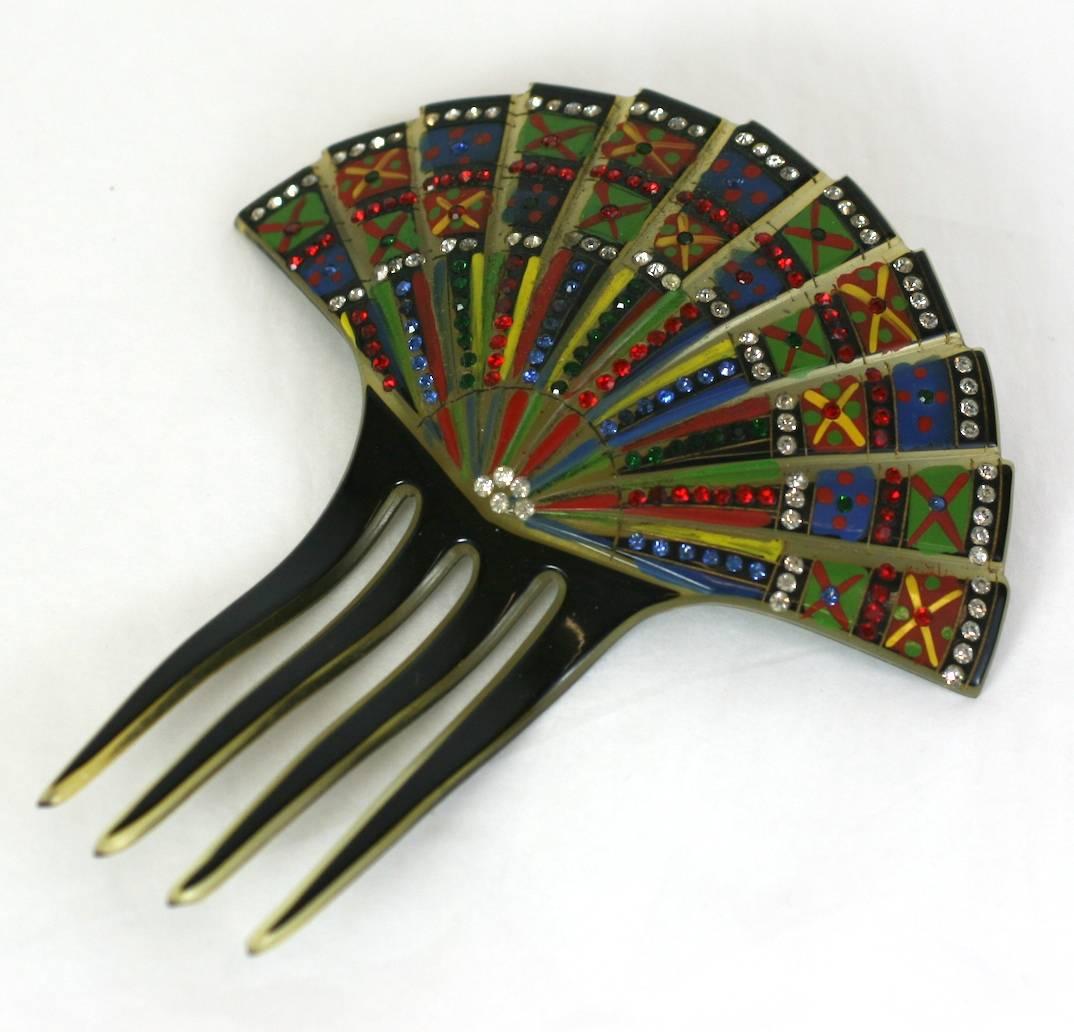 Eygptian Revival Art Deco Comb made in France 1920's. Cold enameled on celluloid and set with multicolored pastes. High quality and striking design. France 1920's. 
5