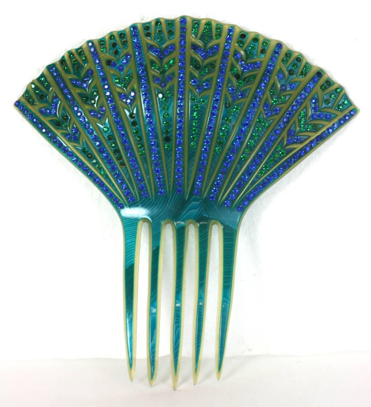 Fine French Art Deco Paste Comb made in France in the 1930's. Clear celluloid  is overlaid with a vibrant turquoise celluloid which is incised and carved away, then hand set with pave rhinestones in blues and greens. Delicate yet elaborate Art Deco
