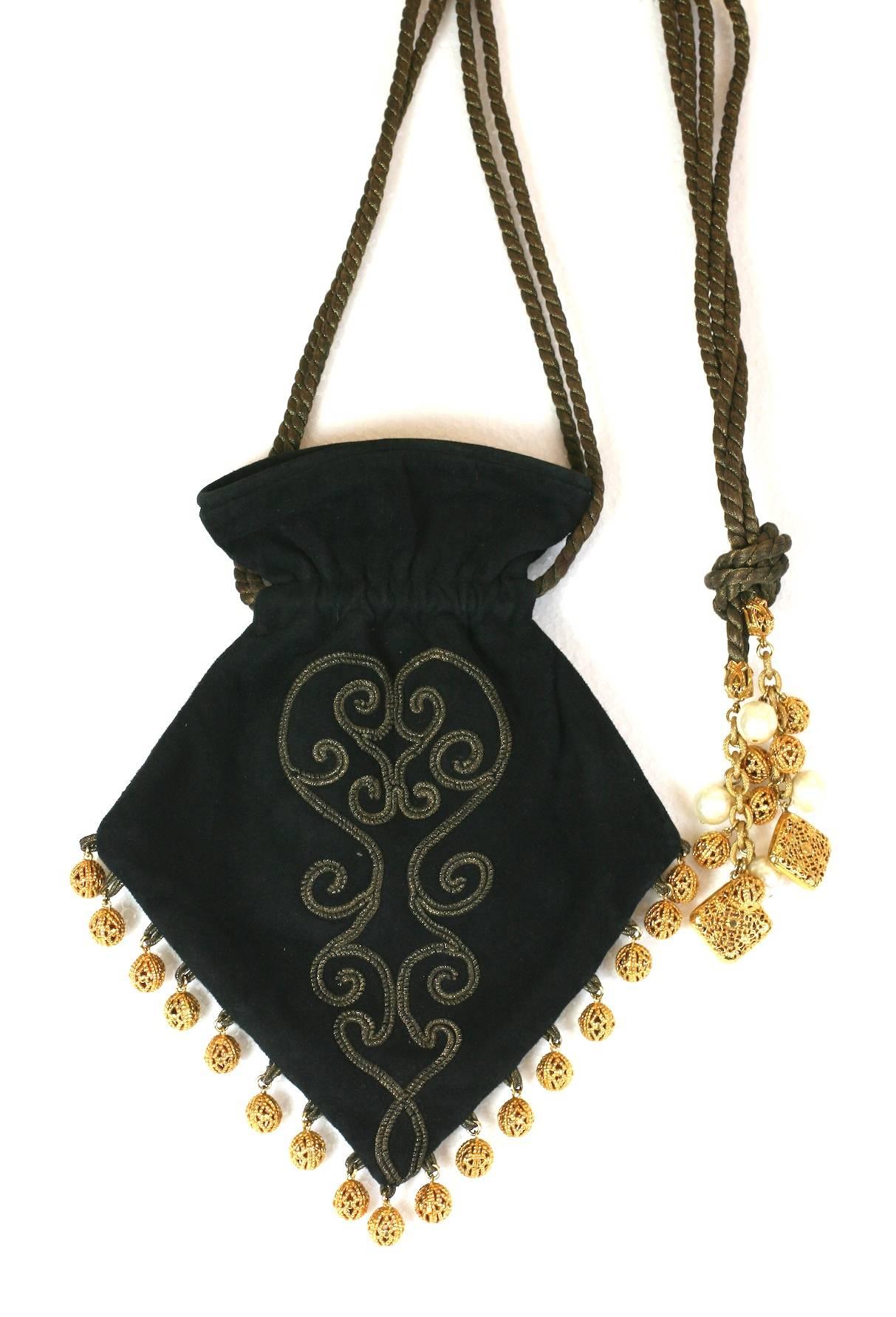 Dominique Aurentis Russian inspired evening drawstring bag, made of black suede, gilt soutache and twisted gilt cord. Further embellished with gold metal filigree ball fringes at the hem and strap (with pearls as well).
Excellent Condition. 1980's