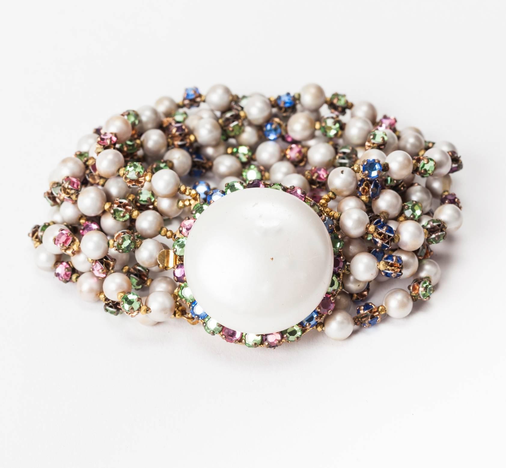 Miriam Haskell bracelet of signature freshwater faux pearls with multicolored pastel crystal, rose monte spacers. Each spacer is hand wired back to back to form a jeweled connector. Striking, wide 8 strand bracelet. Excellent Condition. 1950's USA.