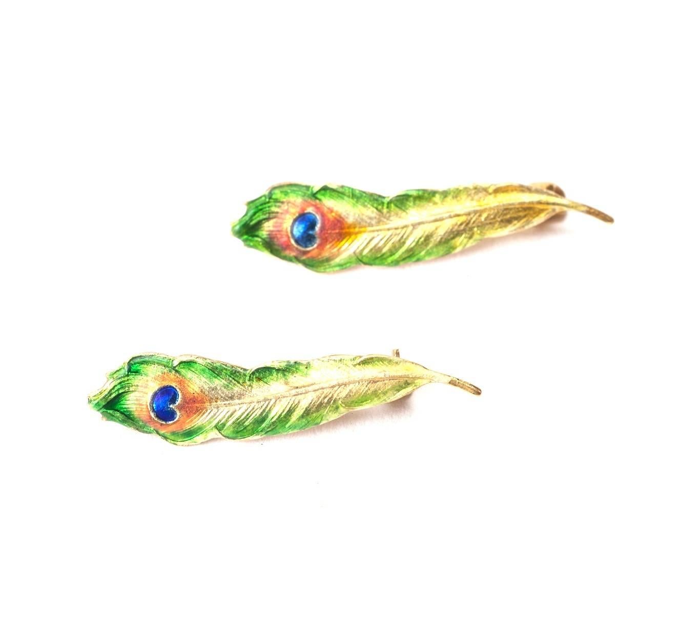 A pair of exquisite Art Nouveau Enamel Feather Brooches in 14K gold by Krementz, N.J. circa 1900.
Lovely Art Nouveau colorations and wonderful quality, for the peacock in all of us. 1