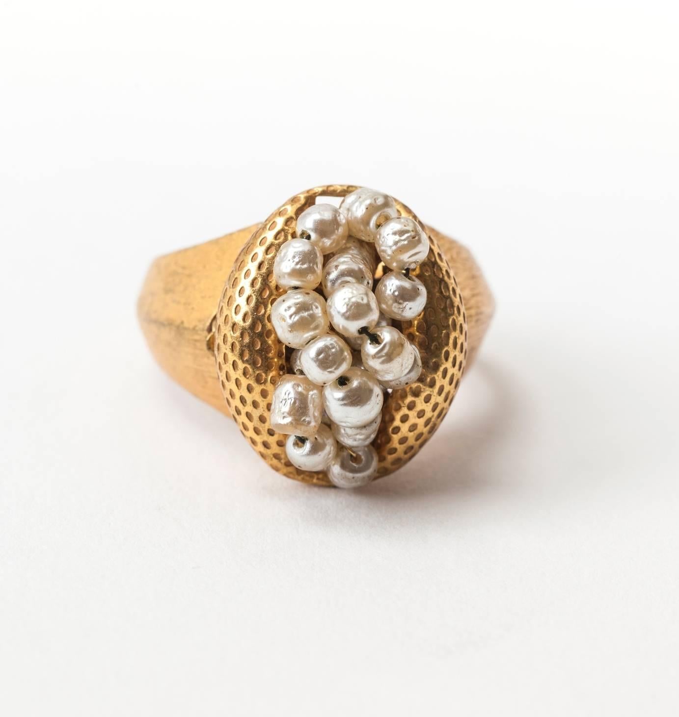 Miriam Haskell hand sewn faux baroque pearl cluster ring in signature Russian Gilt dimpled and textured metal. Signed with oval plaque. Excellent Condition.
Adjustable inner shank. 1950's USA.  Height .75