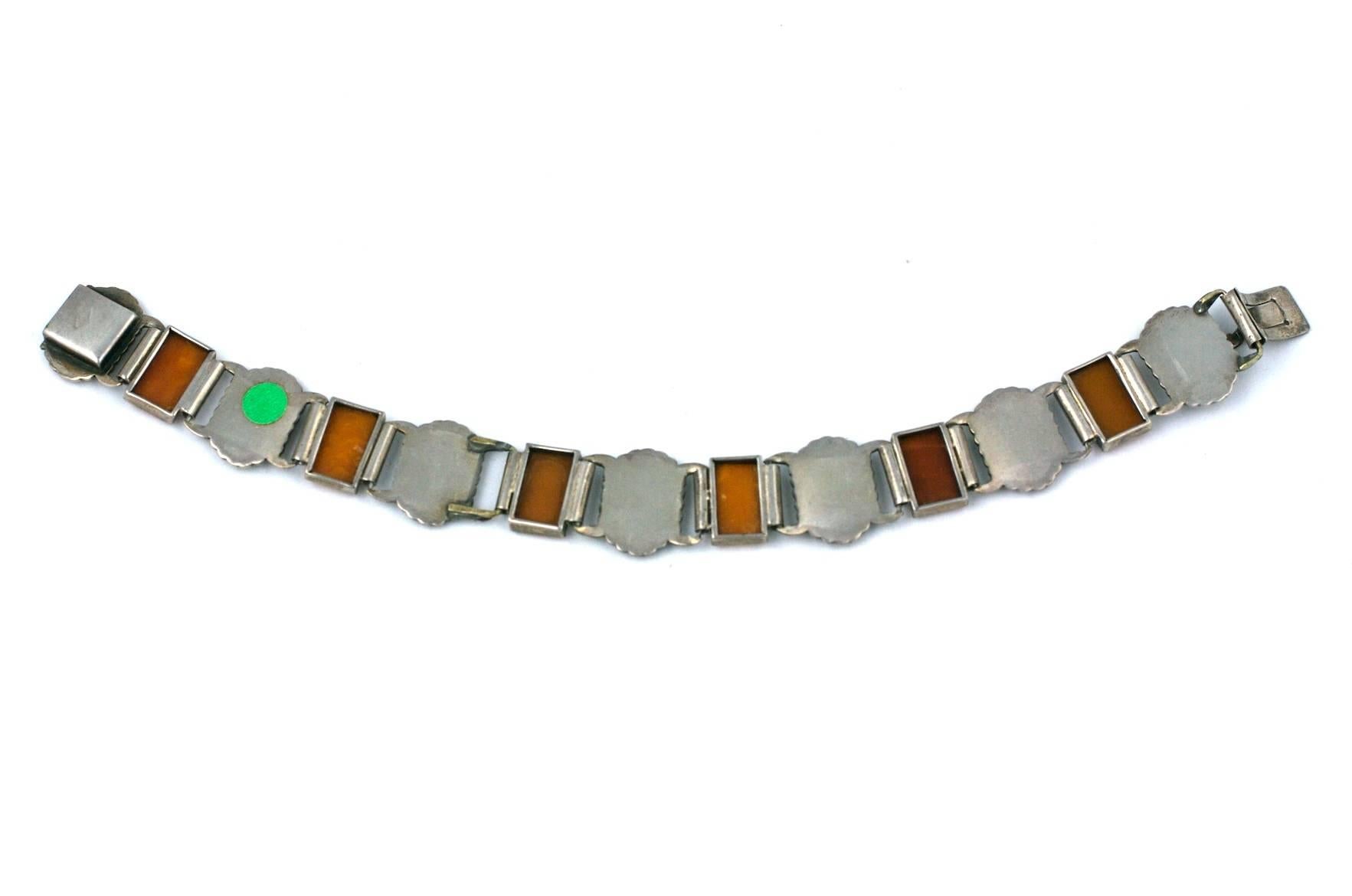 Unusual German Art Deco genuine amber and enamel link bracelet from the 1930's.
Matte lime green enamel contrasts beautifully against the rectangular cut amber stones.
1930's Germany set in 800 grade silver. Excellent condition. 
7