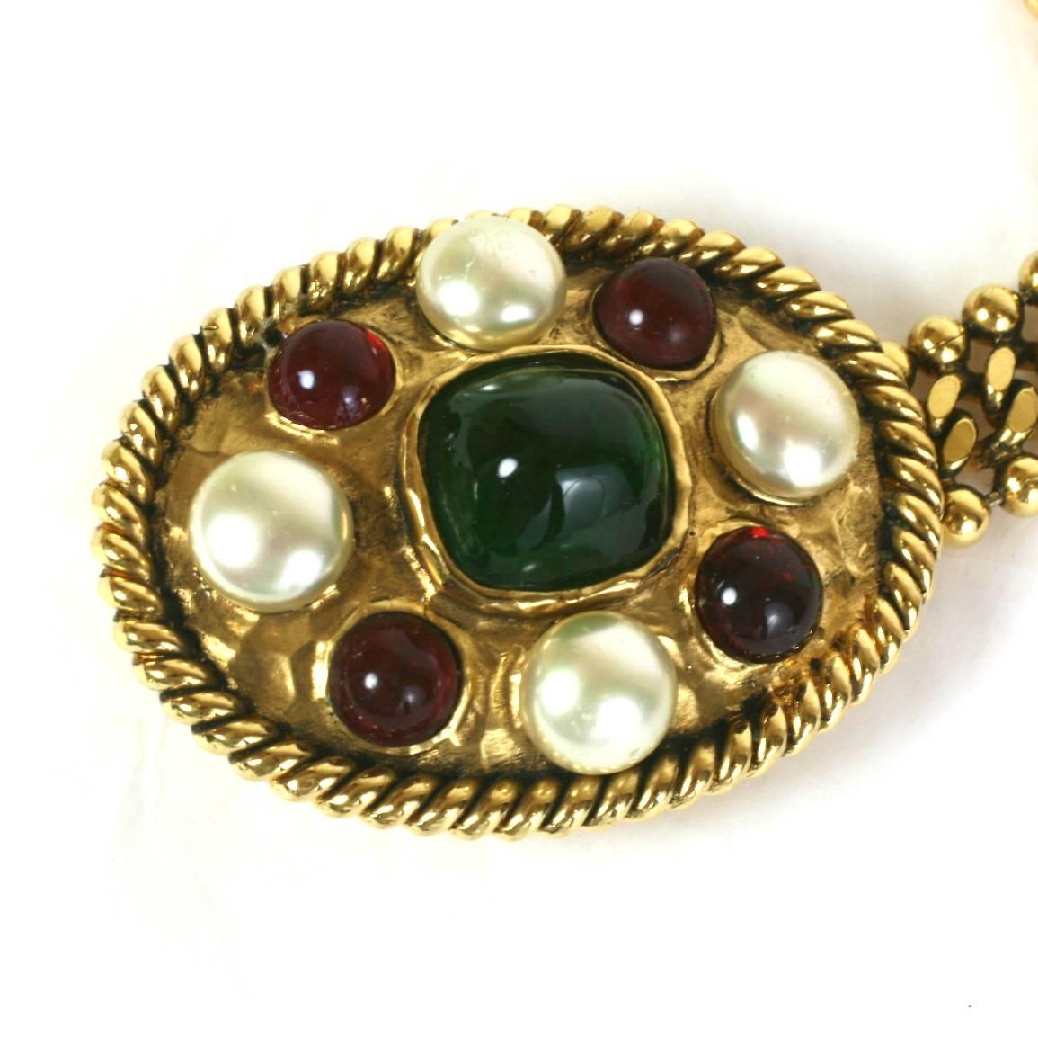 Iconic Chanel Gilt Bronze and Pate de Verre Belt, made by studio Goossens. Ruby and emerald pate de verre cabochons decorate the oval buckle with hand made faux pearls. Adjustable chain link with ruby pate de verre drop. 1980's France. 
Length 33
