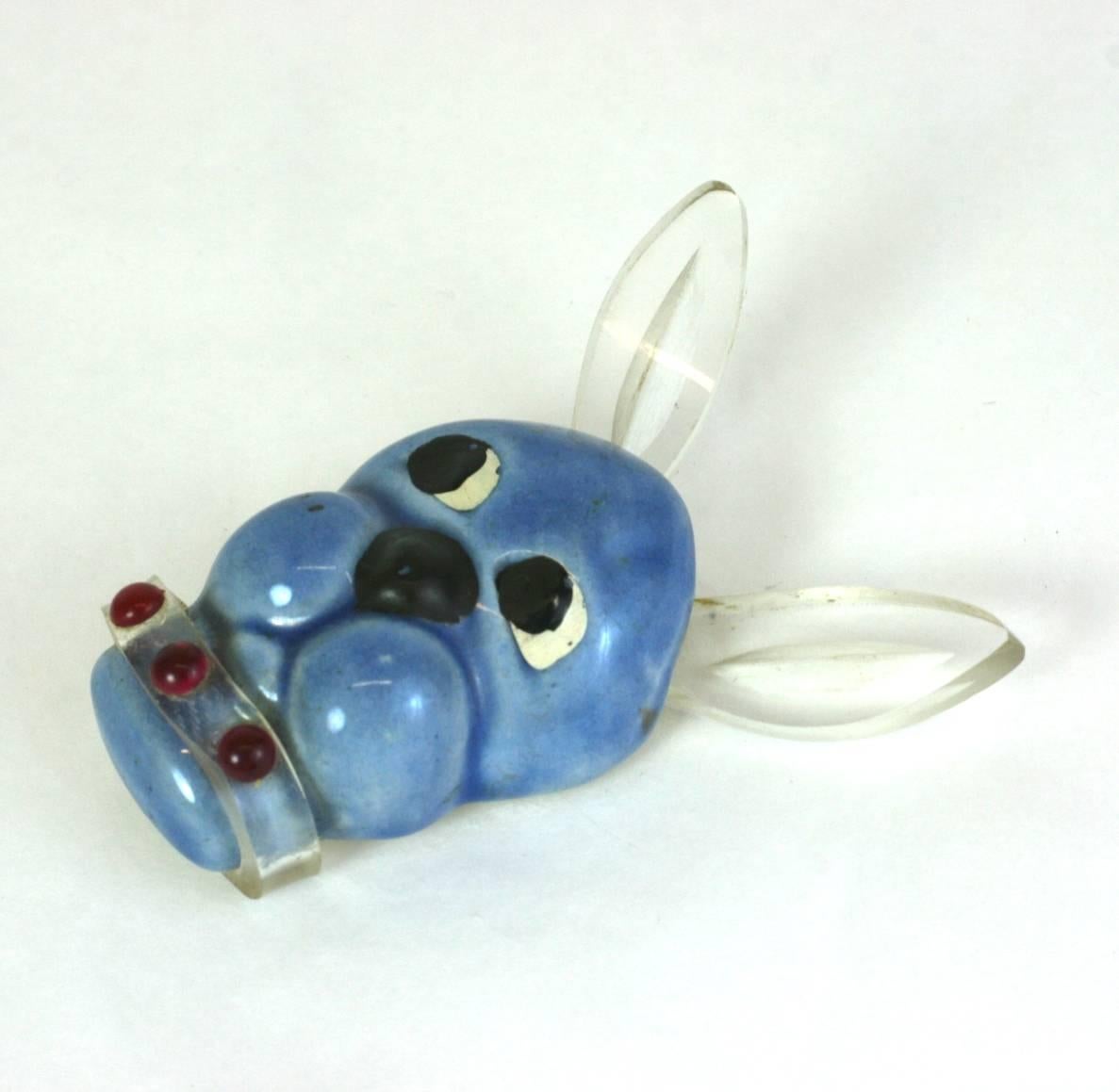 Charming 1940's California Pottery and Lucite Dog brooch by Elzac. Ears and collar are lucite and the pottery head is decorated with over painted details. 
2.25