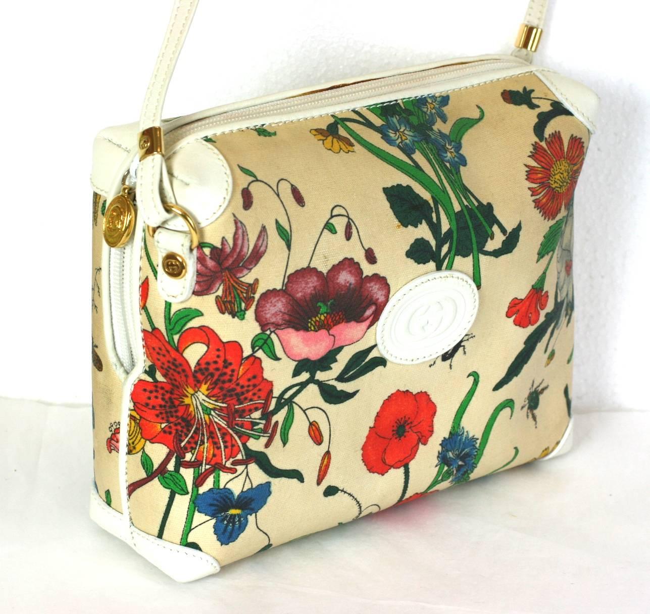 Charming Gucci Floral Print Bag with white leather trim. Signature print of florals and bugs from the 1980's. Resinated canvas. Very Good Condition. 
7.5" x 6" high x 2.5" wide. 
Strap 48