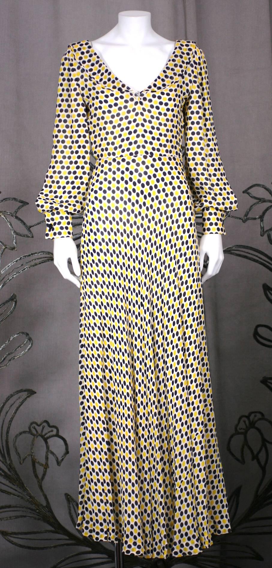 James Galanos vibrant, one piece polka dot crepe gown with flounced ruffle at neckline from the 1970's. Timeless styling and beautifully crafted with an ivory silk chiffon lining and bias piped edges and seams throughout. Bias cut crepe on bodice