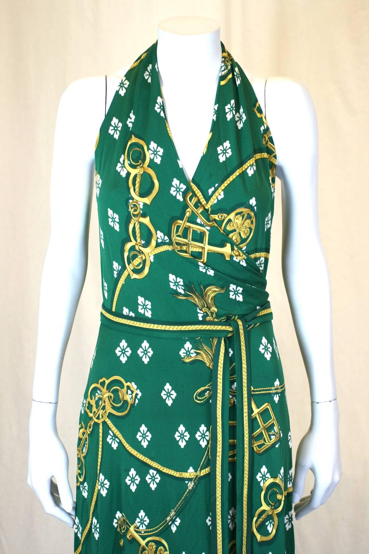Hermes signature scarf print dress in vibrant silk jersey.  Halter neck wrap dress with border print on hem and belt. Self belts and wraps with zipper entry at waist. 1970's France. 
Size French 42, Excellent Condition.
Waist  27