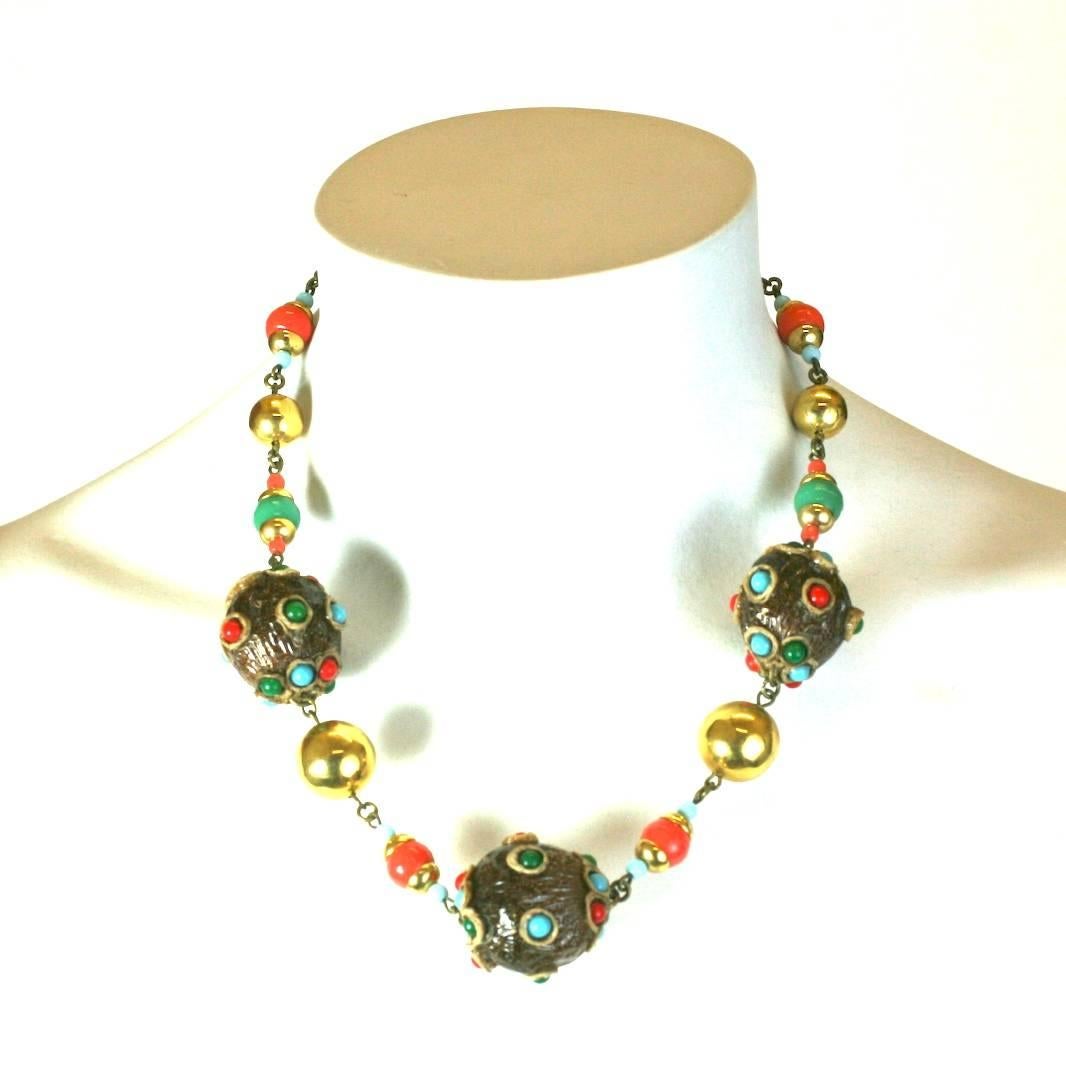Talosel and Pate de Verre Bead necklace by Henry. Unusual walnut like resin form beads are made by hand and inlaid with glass cabochons which are strung with matching gilt metal and glass beads. Unsigned. 1950's France. 
Excellent condition.