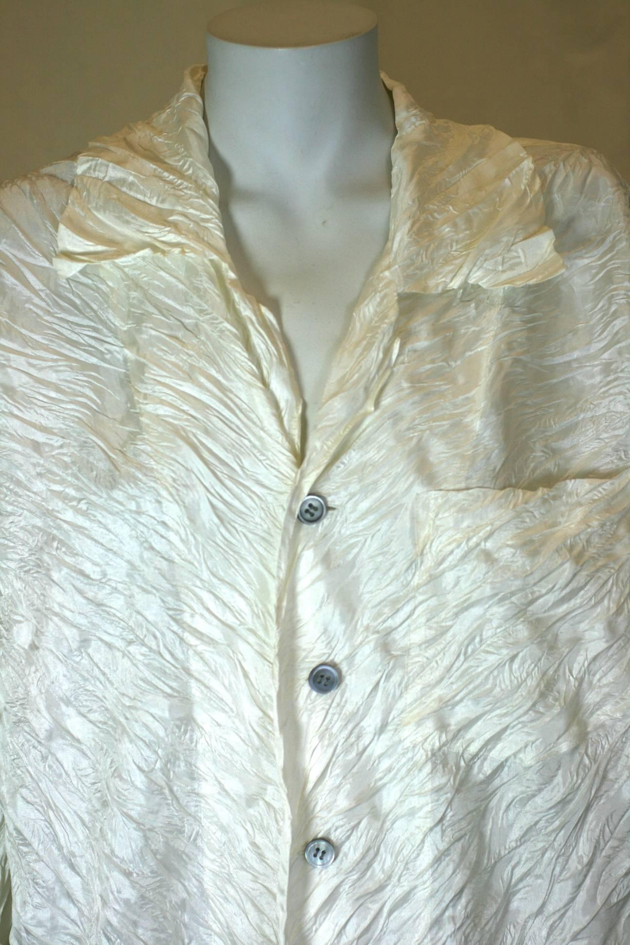 Issey Miyake Bias Crinkle Pleated Ivory Blouse. A simple mans shirt given new life with Miyake's signature pleating process. Shell buttons. Excellent Condition. 2000's Japan. Size: Small.  Unstretched measures: Length 29