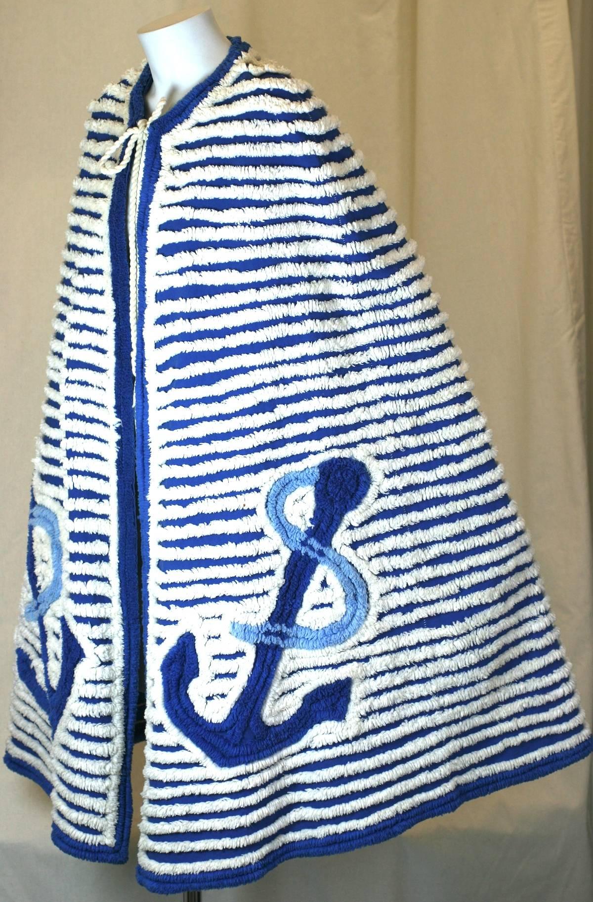 Charming Art Deco Chenille Cape in shades of blue and white. Nautical themed with anchor motifs on front. Ties simply at neck. 1940's USA. 
Excellent condition.
Length 38