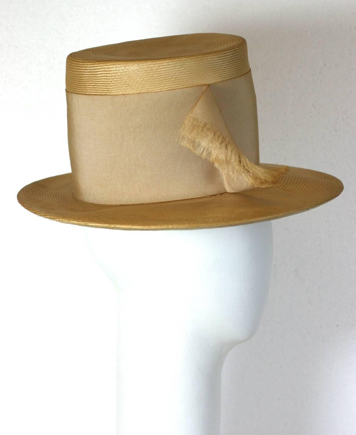 Charming, finely woven straw hat with graduated brim and high crown with wide grosgrain ribbon trim. 1960's Italy.
Crown 5.5