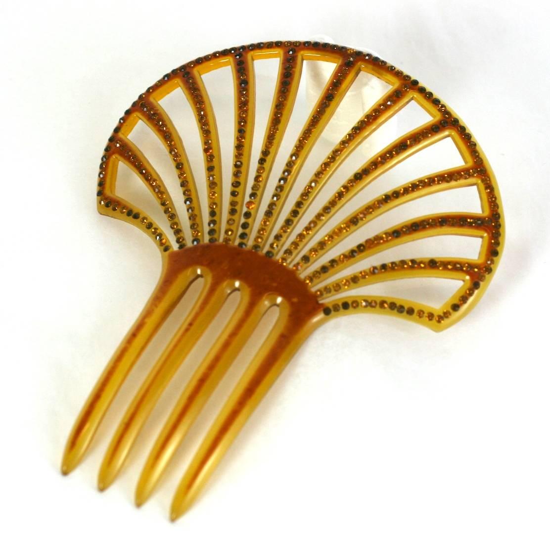 Art Deco Pierced Celluloid Comb from the 1920's. The celluloid has been patinaed and dozens of citrine pastes have been set along the openwork fan shape. France 1920's. Excellent condition. 