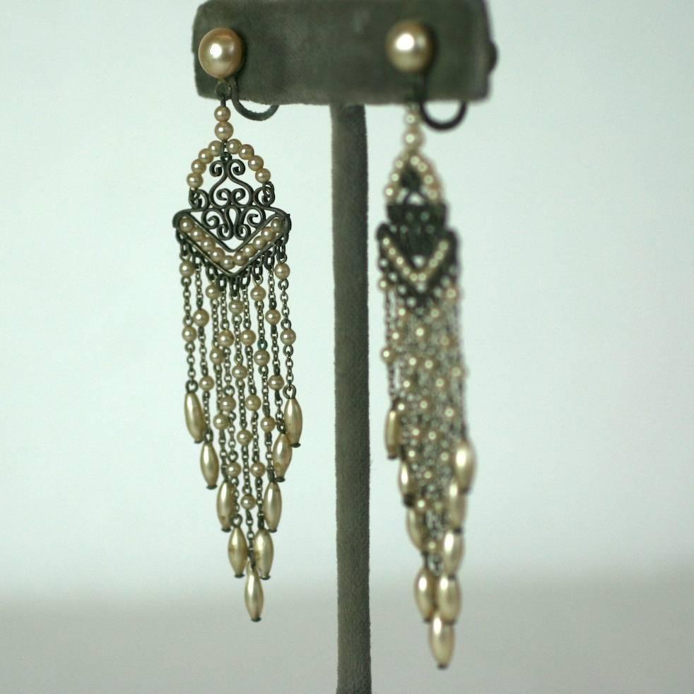 Attractive Art Deco faux pearl fringe earrings from the 1930's. Tiny faux pearls are strung on a pierced fretwork and off graduating chains. Screw back fittings.
1930's France. Excellent condition. 
3.25